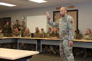 Chief Master Sgt. Travon Dennis, Fourth Air Force command chief from March Air Reserve Base, California, speaks with 445th Rising 6 members during his visit at Wright-Patterson Air Force Base, Ohio, Jan. 6, 2024.