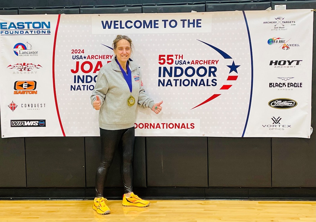 Jamie McCarrison posing with a gold medal around her neck.