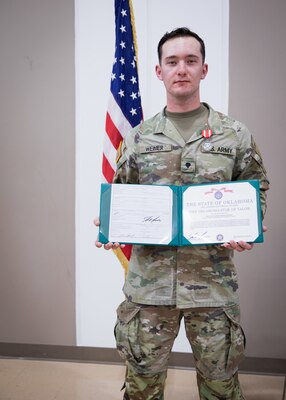 Spc. Alexander Weimer, assigned to Bravo Company, 545th Brigade Engineer Battalion, 45th Infantry Brigade Combat Team, Oklahoma Army National Guard, poses at his Oklahoma Star of Valor Ceremony at the Muskogee Armed Forces Reserve Center, Muskogee, Oklahoma, March 3, 2024. Weimer was recognized for his bravery and compassion while assisting civilians involved in a vehicular collision while on his way to drill. (Oklahoma Army National Guard by Cpl. Danielle Rayon)