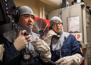 ABH3 Monika Young operates as a phone talker during a damage control drill aboard USS Makin Island (LHD 8).