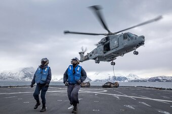 Sailors return from hooking cargo to an Italian navy helicopter aboard  USS Gunston Hall (LSD 44) during Steadfast Defender.