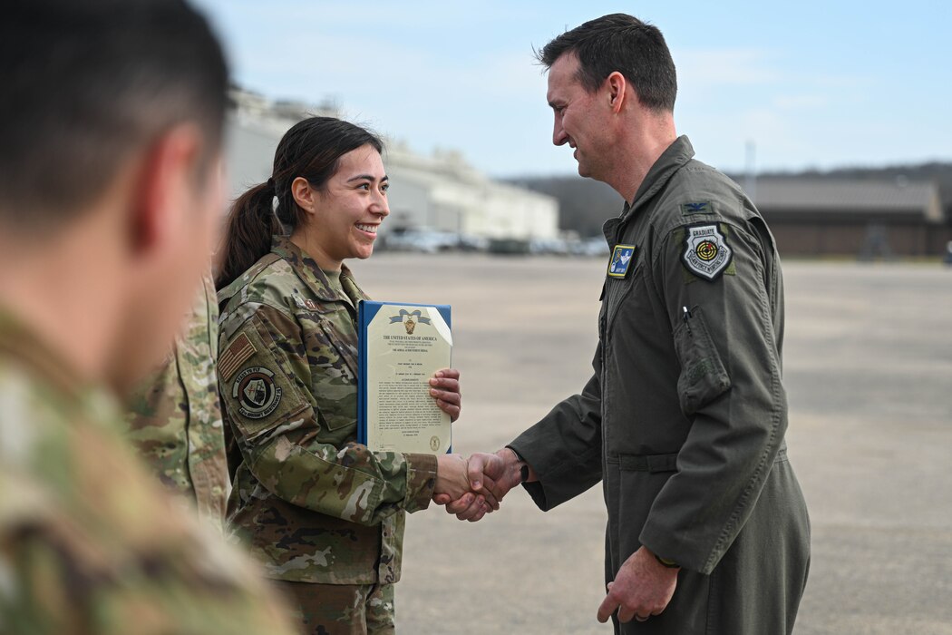 Staff Sgt. Toni Medina, 41st Airlift Squadron flying crew chief, accepts a coin for their performance during a recent maximum endurance operation at Little Rock Air Force Base, Arkansas, Feb. 26, 2024. During the operation, two C-130J Super Hercules from the 41st Airlift Squadron conducted a roughly 30-hour single-aircraft maximum endurance mission demonstrating multi-day mission generation capabilities while only landing to refuel.