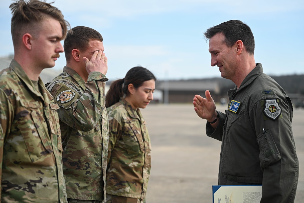 Staff Sgt. Fredrick Crowl, 41st Airlift Squadron flying crew chief, accepts a coin for their performance during a recent maximum endurance operation at Little Rock Air Force Base, Arkansas, Feb. 26, 2024. During the operation, two C-130J Super Hercules from the 41st Airlift Squadron conducted a roughly 30-hour single-aircraft maximum endurance mission demonstrating multi-day mission generation capabilities while only landing to refuel.