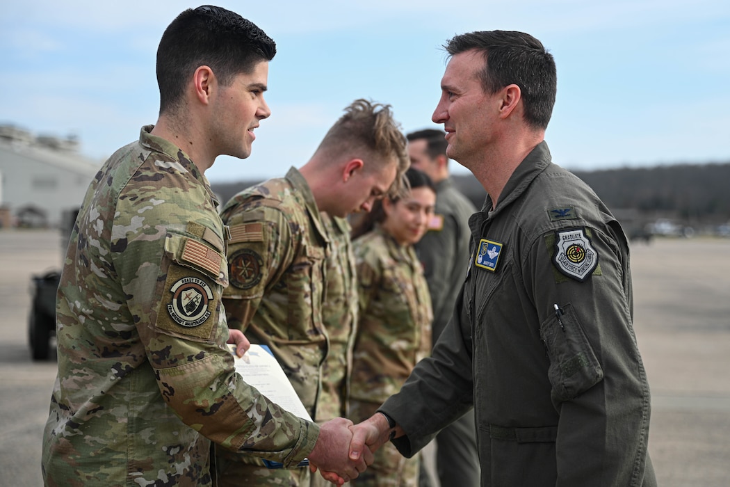 Staff Sgt. Bailey Empey, 41st Airlift Squadron flying crew chief, accepts a coin for their performance during a recent maximum endurance operation at Little Rock Air Force Base, Arkansas, Feb. 26, 2024. During the operation, two C-130J Super Hercules from the 41st Airlift Squadron conducted a roughly 30-hour single-aircraft maximum endurance mission demonstrating multi-day mission generation capabilities while only landing to refuel.