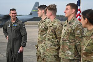 Airmen accept a coin for their performance during a recent maximum endurance operation at Little Rock Air Force Base, Arkansas, Feb. 26, 2024. During the operation, two C-130J Super Hercules from the 41st Airlift Squadron conducted a roughly 30-hour single-aircraft maximum endurance mission demonstrating multi-day mission generation capabilities while only landing to refuel.