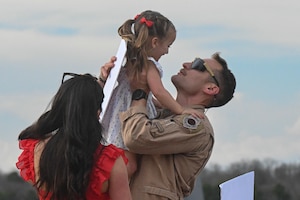 An Airman greets family members.