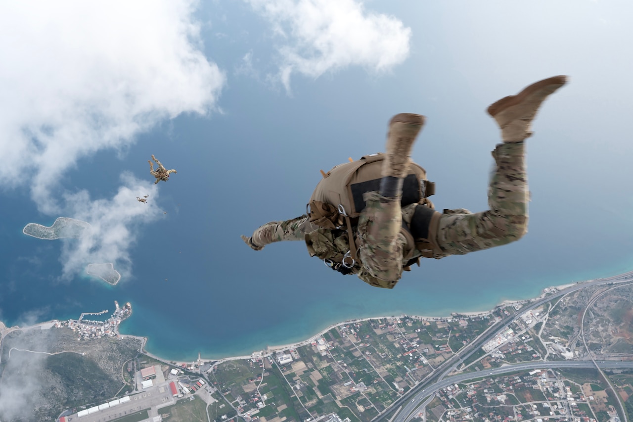 A Green Beret jumps out an aircraft.