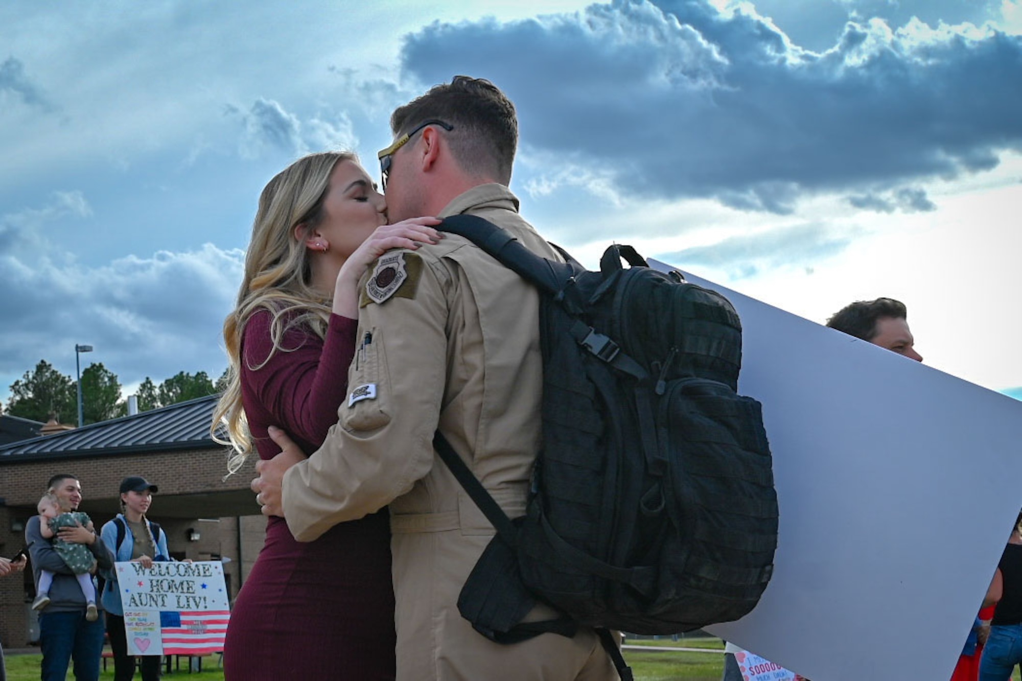 An Airman greets family members.