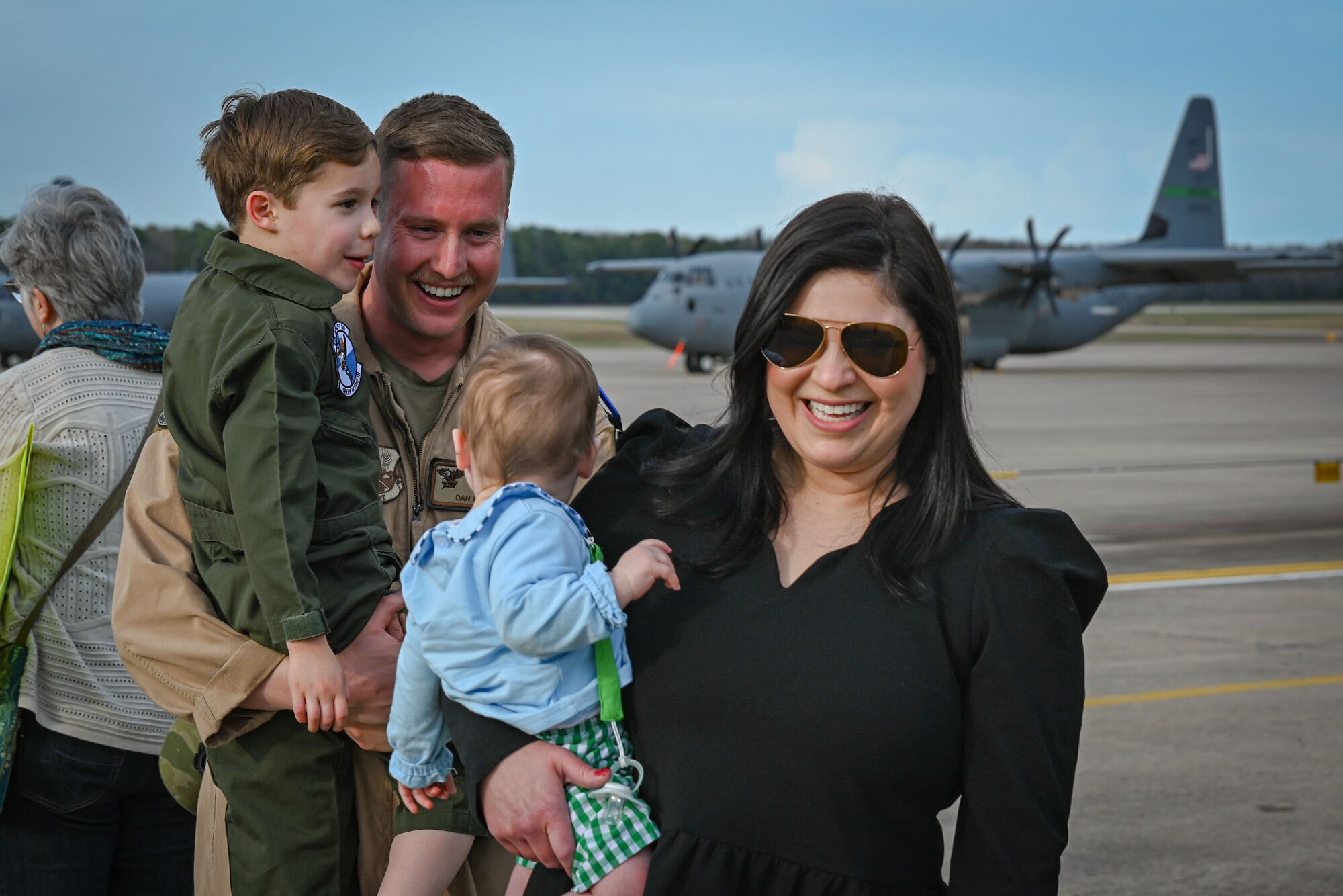 An Airman greets family members.