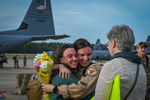 An Airman greets family members.