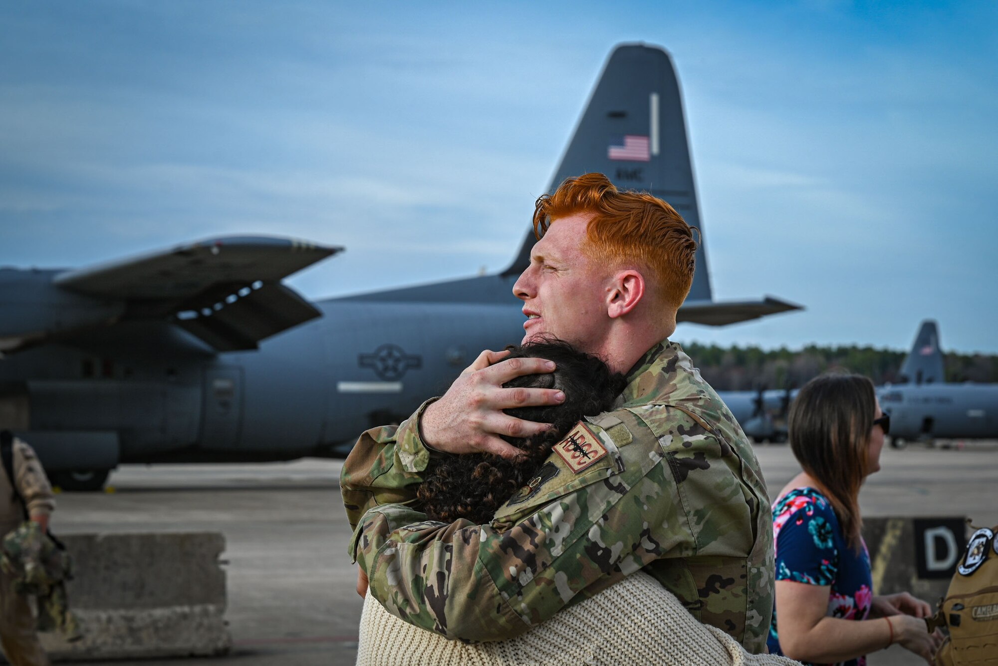 An Airman greets family members.