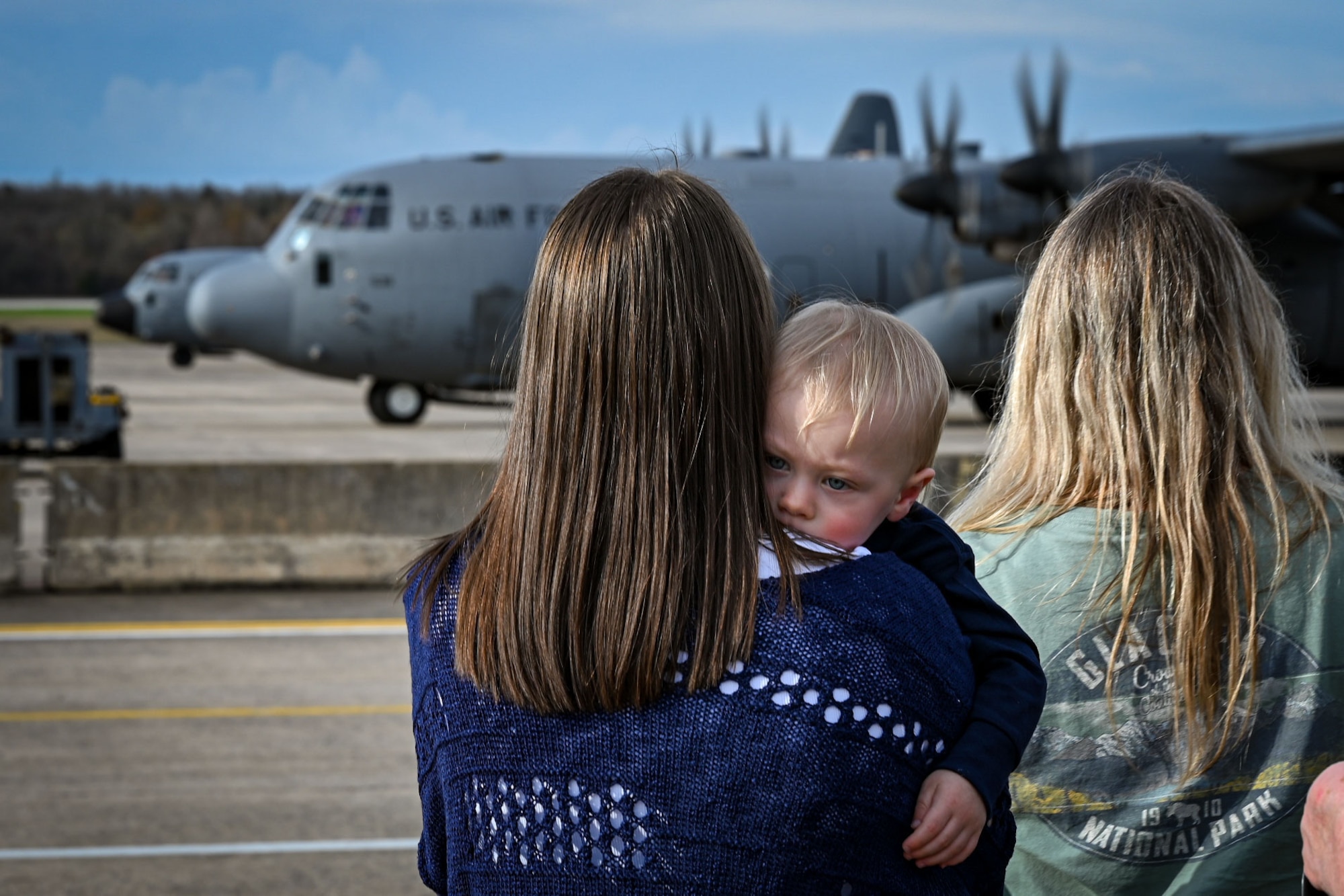 Families wait on the flightline.