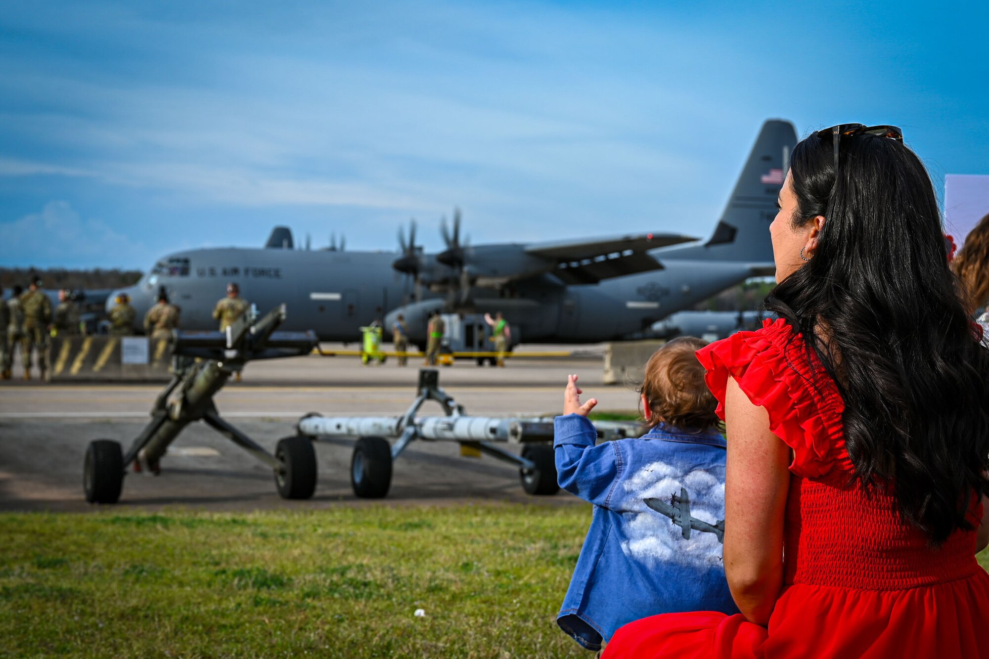 Families sit on the flightline.
