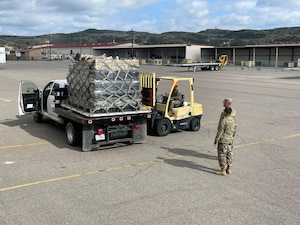 U.S. Air Force Capt. Dee Hawes provides direction for the shipment of Tactical Operations Center-Light, or TOC-L, kits