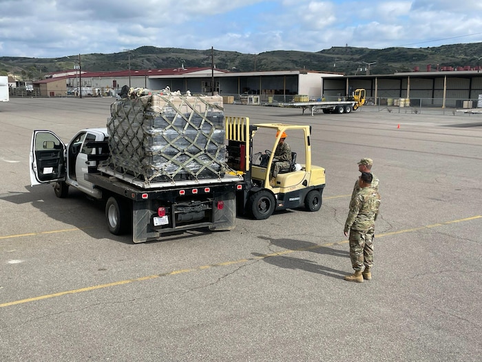 U.S. Air Force Capt. Dee Hawes provides direction for the shipment of Tactical Operations Center-Light, or TOC-L, kits