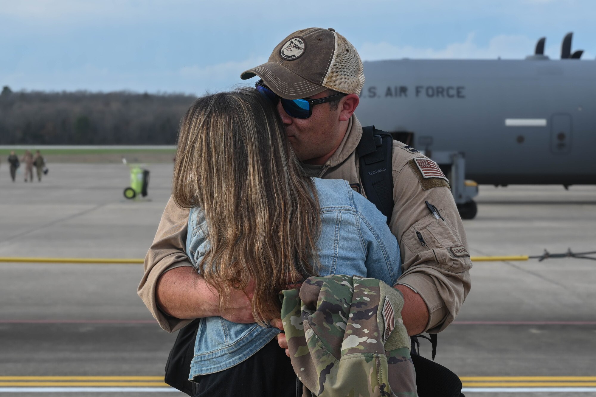 An Airman greets family.