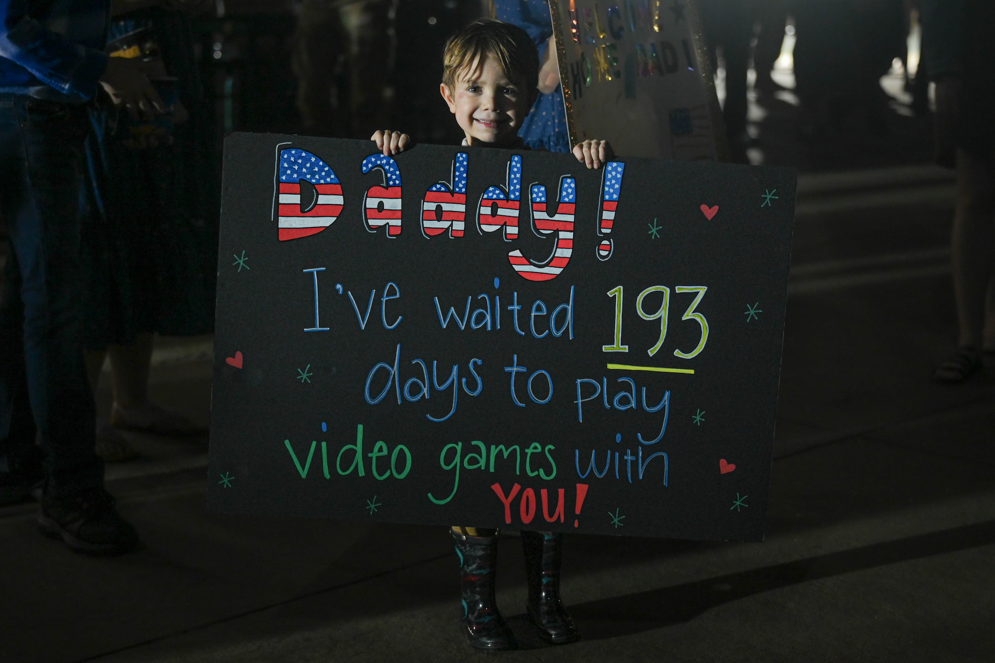 A child holds a sign.