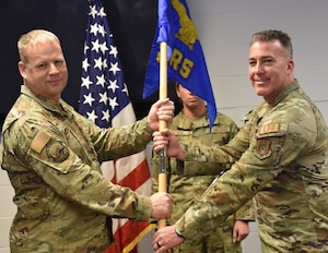 Maj. Martin Hanley receives the flag and thereby command of the 914th Logistics Readiness Squadron.