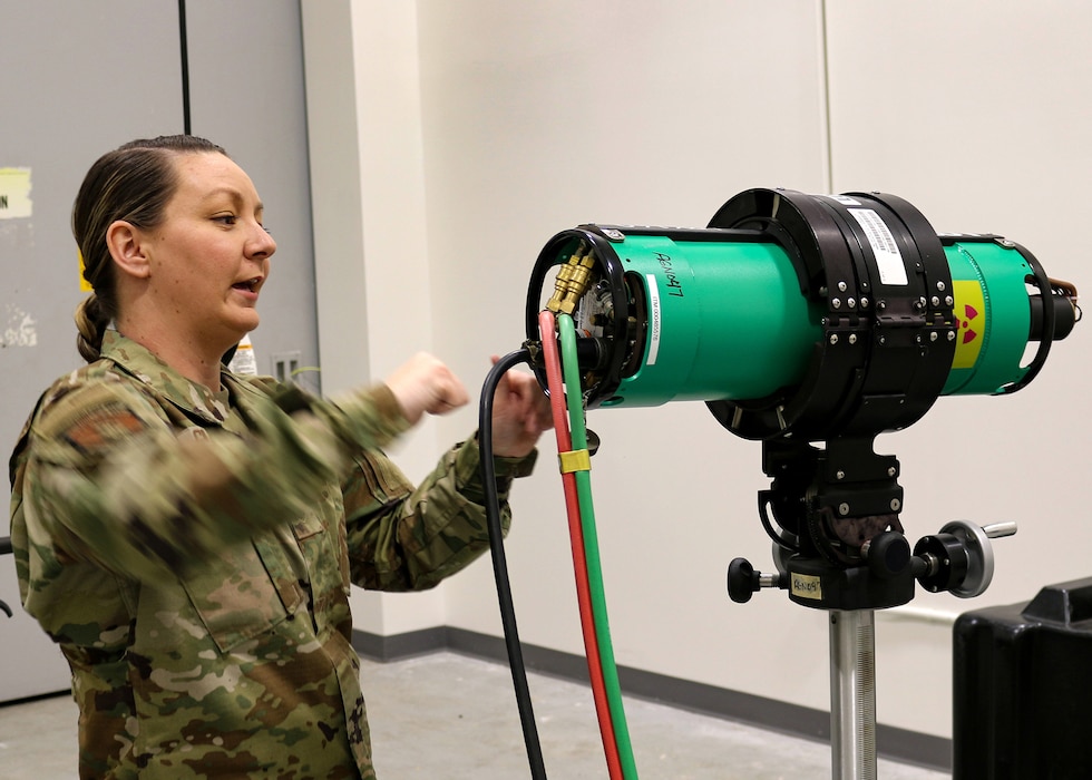 Senior Airman Stephanie Gillispie, 445th Maintenance Squadron non-destructive inspector, demonstrates how an X-ray image is taken of an aircraft using radiation at Wright-Patterson Air Force Base, Ohio, Feb. 4, 2024.