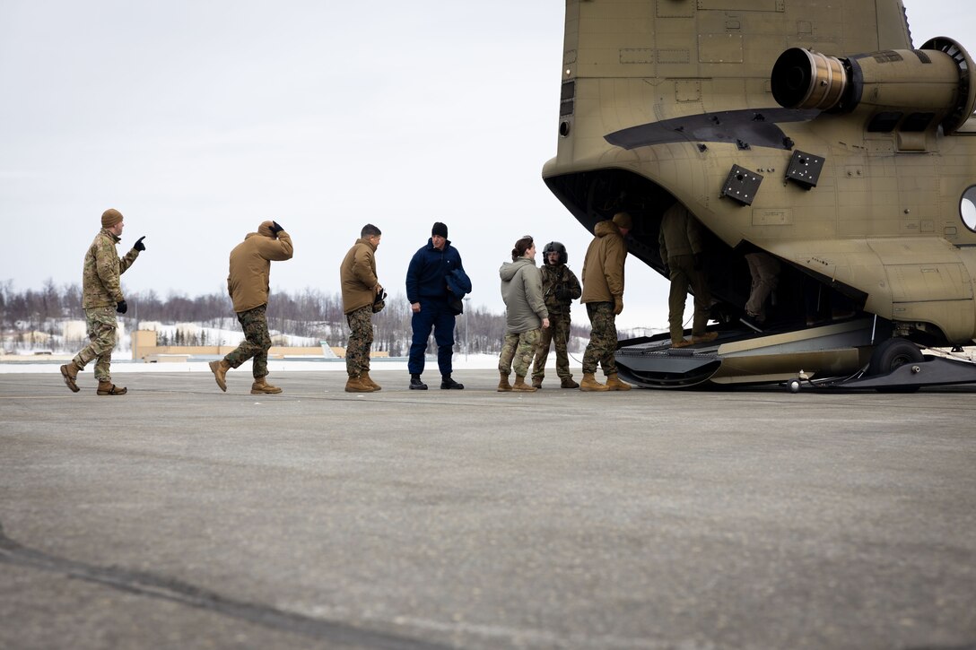 U.S. Marine Corps Maj. Gen. John Kelliher, Commanding General, 4th Marine Aircraft Wing, U.S. Marine Corps Forces Reserve, boards a Boeing CH-47 Chinook aircraft alongside a joint-service delegation during Distinguished Visitor’s (DV) Day as part of exercise Arctic Edge 2024 (AE24) at Joint Base Elmendorf-Richardson, Alaska, March 4, 2024. The delegation visited and toured Port MacKenzie. AE24 DV Day served as a dynamic forum and facilitated discussions among military leaders, government officials, and academic experts on key issues related to the future of homeland defense in the arctic. The event featured site visits, demonstrations, and presentations, emphasizing the integration of diverse perspectives to strengthen regional partnerships. Arctic Edge 2024 is a U.S. Northern Command-led homeland defense exercise demonstrating the U.S. military’s capabilities in extreme cold weather, joint force readiness, and U.S. military commitment to mutual strategic security interests in the arctic region. (U.S. Marine Corps photo by Lance Cpl. Madisyn Paschal)