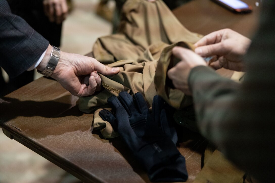 Mr. Yoel Fink, Professor of Materials Science and Engineering, Massachusetts Institute of Technology, demonstrates Fabric-Embedded Temperature Sensors to a joint-service delegation during Distinguished Visitor’s (DV) Day as part of exercise Arctic Edge 2024 (AE24) at Joint Base Elmendorf-Richardson, Alaska, March 4, 2024. The delegation visited and toured Camp Mad Bull, a site conducting several medical experiments in an arctic environment utilizing freeze dried plasma, portable oxygen generators, hypothermia prevention devices, core temperature monitors and more. AE24 DV Day fostered dynamic discussions among military, government, and academic leaders on arctic homeland defense, later featuring site visits, demonstrations, and presentations. Arctic Edge 2024 is a U.S. Northern Command-led homeland defense exercise demonstrating the U.S. military’s capabilities in extreme cold weather, joint force readiness, and U.S. military commitment to mutual strategic security interests in the arctic region. (U.S. Marine Corps photo by Lance Cpl. Madisyn Paschal)