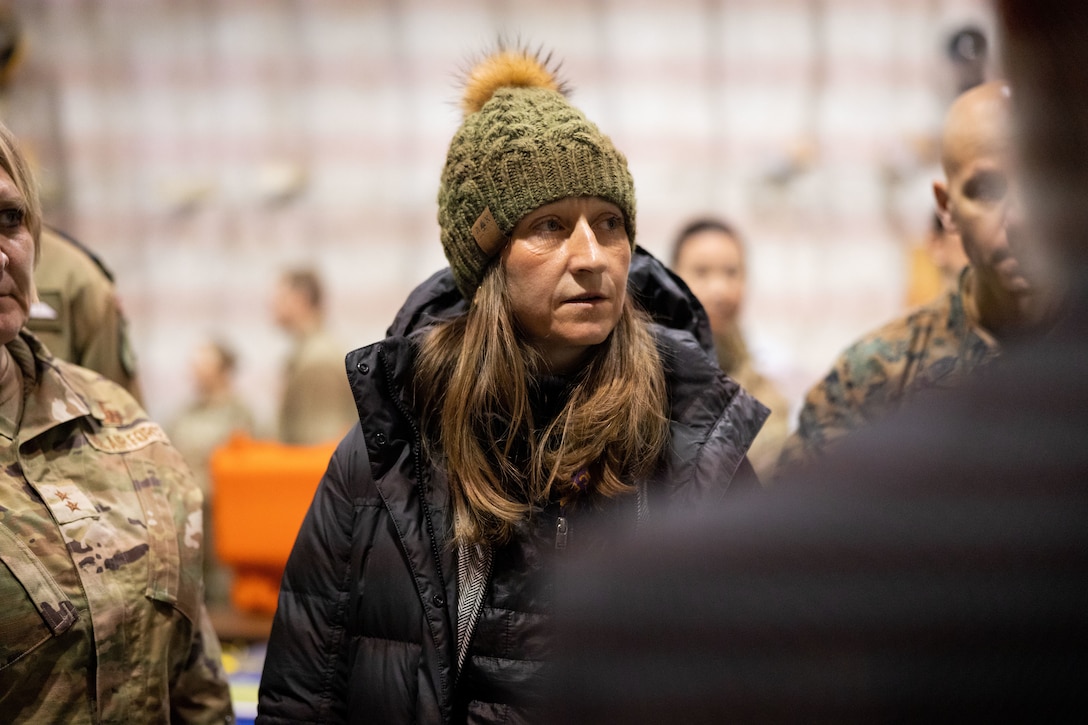 Ms. Iris Ferguson, Deputy Assistant Secretary of Defense for Arctic and Global Resilience, listens to a demonstration detailing the benefits of Fabric-Embedded Temperature Sensors in arctic conditions alongside a joint-service delegation during Distinguished Visitor’s (DV) Day as part of exercise Arctic Edge 2024 (AE24) at Joint Base Elmendorf-Richardson, Alaska, March 4, 2024. The delegation visited and toured Camp Mad Bull, a site conducting several medical experiments in an arctic environment utilizing freeze dried plasma, portable oxygen generators, hypothermia prevention devices, core temperature monitors and more. AE24 DV Day fostered dynamic discussions among military, government, and academic leaders on arctic homeland defense, later featuring site visits, demonstrations, and presentations. Arctic Edge 2024 is a U.S. Northern Command-led homeland defense exercise demonstrating the U.S. military’s capabilities in extreme cold weather, joint force readiness, and U.S. military commitment to mutual strategic security interests in the arctic region. (U.S. Marine Corps photo by Lance Cpl. Madisyn Paschal)