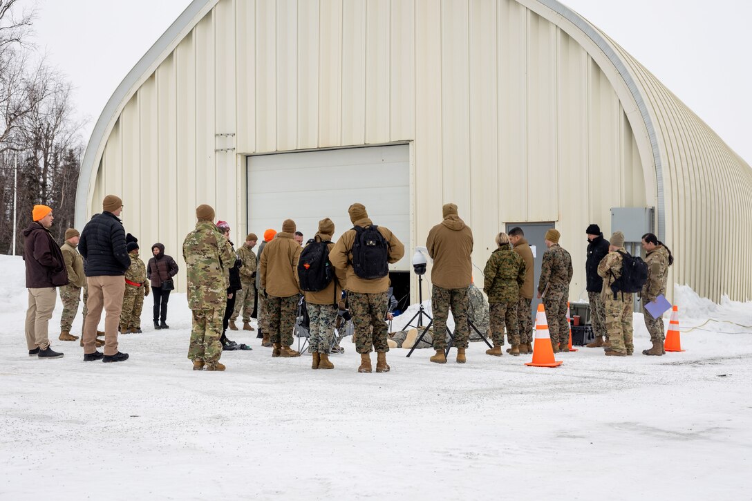 U.S. Marine Corps Maj. Gen. John Kelliher, Commanding General, 4th Marine Aircraft Wing, U.S. Marine Corps Forces Reserve, observes a demonstration of Tactical Combat Casualty Care (TCCC) under arctic conditions alongside a joint-service delegation during Distinguished Visitor’s (DV) Day as part of exercise Arctic Edge 2024 (AE24) at Joint Base Elmendorf-Richardson, Alaska, March 4, 2024. The delegation visited and toured Camp Mad Bull, a site conducting several medical experiments in an arctic environment utilizing freeze dried plasma, portable oxygen generators, hypothermia prevention devices, core temperature monitors and more. AE24 DV Day fostered dynamic discussions among military, government, and academic leaders on arctic homeland defense, later featuring site visits, demonstrations, and presentations. Arctic Edge 2024 is a U.S. Northern Command-led homeland defense exercise demonstrating the U.S. military’s capabilities in extreme cold weather, joint force readiness, and U.S. military commitment to mutual strategic security interests in the arctic region. (U.S. Marine Corps photo by Lance Cpl. Madisyn Paschal)