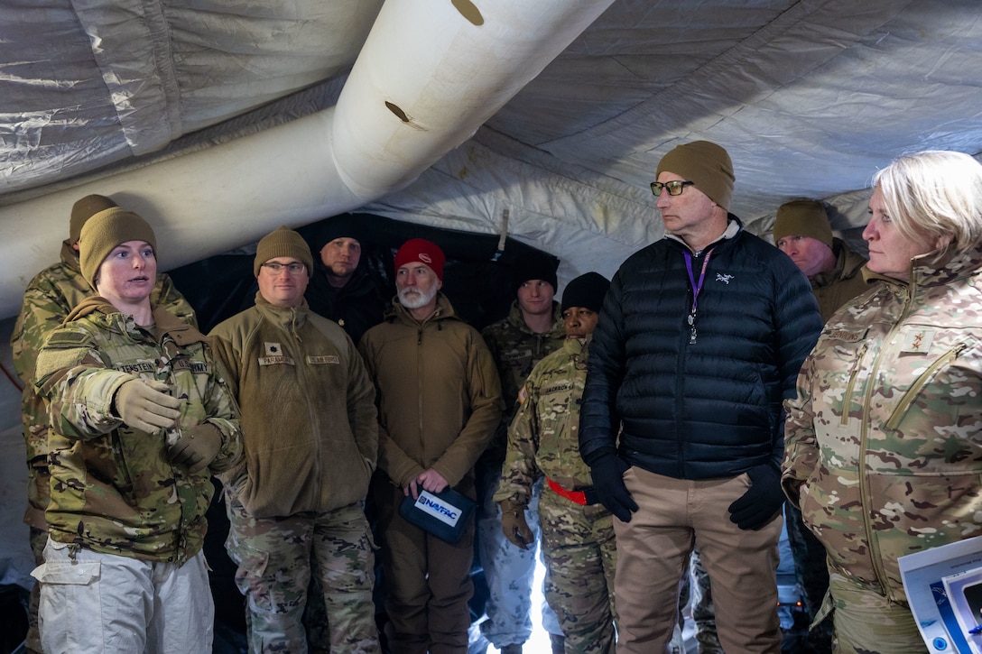 U.S. Army 1st Lt. Sydney Feltenstein, a combat medic with 3rd Battalion, 509th Infantry Airborne, explains the operations within a medical tent to a joint-service delegation during Distinguished Visitor’s (DV) Day as part of exercise Arctic Edge 2024 (AE24) at Joint Base Elmendorf-Richardson, Alaska, March 4, 2024. The delegation visited and toured Camp Mad Bull, a site conducting several medical experiments in an arctic environment utilizing freeze dried plasma, portable oxygen generators, hypothermia prevention devices, core temperature monitors and more. AE24 DV Day fostered dynamic discussions among military, government, and academic leaders on arctic homeland defense, later featuring site visits, demonstrations, and presentations. Arctic Edge 2024 is a U.S. Northern Command-led homeland defense exercise demonstrating the U.S. military’s capabilities in extreme cold weather, joint force readiness, and U.S. military commitment to mutual strategic security interests in the arctic region. (U.S. Marine Corps photo by Lance Cpl. Madisyn Paschal)