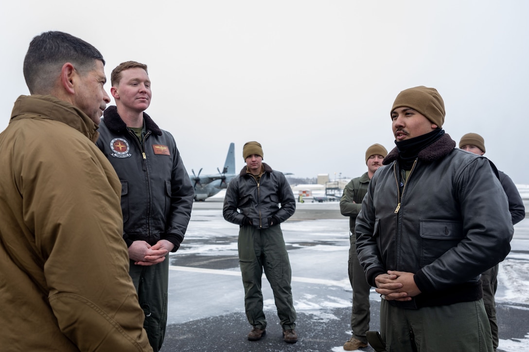 U.S. Marine Corps Maj. Gen. John Kelliher, Commanding General, 4th Marine Aircraft Wing, Marine  Forces Reserve, recognizes Lance Cpl. Anthony Gawne, a Fixed-Wing Aircraft Loadmaster with Marine Aerial Refueler Transport Squadron (VMGR) 234, Marine Aircraft Group 41, 4th Marine Aircraft Wing, Marine Forces Reserve, for his display of proficiency, adaptability and endurance throughout exercise Arctic Edge 2024 (AE24) at Joint Base Elmendorf-Richardson, Alaska, March 4, 2024. Training in an arctic environment cultivates a resilient force adept at adapting to extreme conditions, guaranteeing preparedness for potential conflicts in challenging terrains, and augmenting the overall proficiency of armed forces to operate effectively in diverse and demanding scenarios. Arctic Edge 2024 is a U.S. Northern Command-led homeland defense exercise demonstrating the U.S. military’s capabilities in extreme cold weather, joint force readiness, and U.S. military commitment to mutual strategic security interests in the arctic region. (U.S. Marine Corps photo by Lance Cpl. Madisyn Paschal)