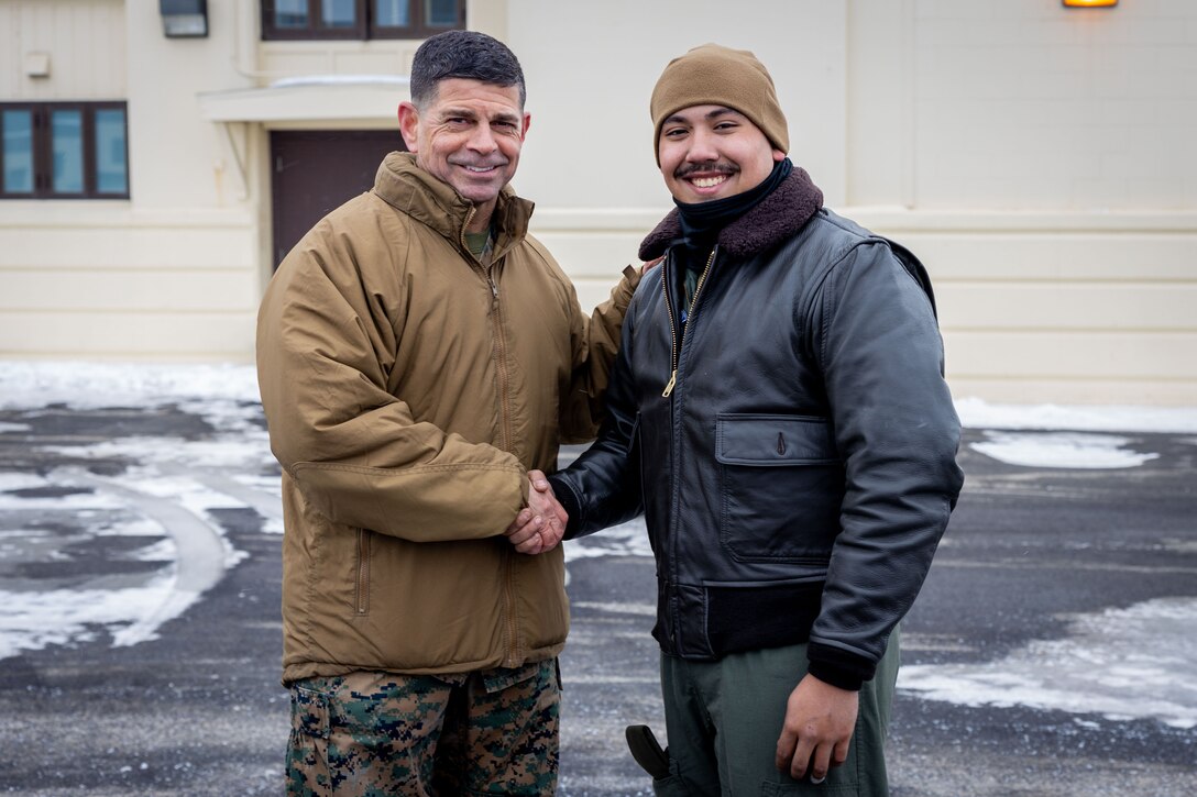 U.S. Marine Corps Maj. Gen. John Kelliher, Commanding General, 4th Marine Aircraft Wing, Marine Forces Reserve, recognizes Lance Cpl. Anthony Gawne, a Fixed-Wing Aircraft Loadmaster with Marine Aerial Refueler Transport Squadron (VMGR) 234, Marine Aircraft Group 41, 4th Marine Aircraft Wing, Marine Forces Reserve, for his display of proficiency, adaptability and endurance throughout exercise Arctic Edge 2024 (AE24) and presents him with a challenge coin at Joint Base Elmendorf-Richardson, Alaska, March 4, 2024. Training in an arctic environment cultivates a resilient force adept at adapting to extreme conditions, guaranteeing preparedness for potential conflicts in challenging terrains, and augmenting the overall proficiency of armed forces to operate effectively in diverse and demanding scenarios. Arctic Edge 2024 is a U.S. Northern Command-led homeland defense exercise demonstrating the U.S. military’s capabilities in extreme cold weather, joint force readiness, and U.S. military commitment to mutual strategic security interests in the arctic region. (U.S. Marine Corps photo by Lance Cpl. Madisyn Paschal)