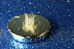 Metal shavings stand vertically atop a rare earth magnet.