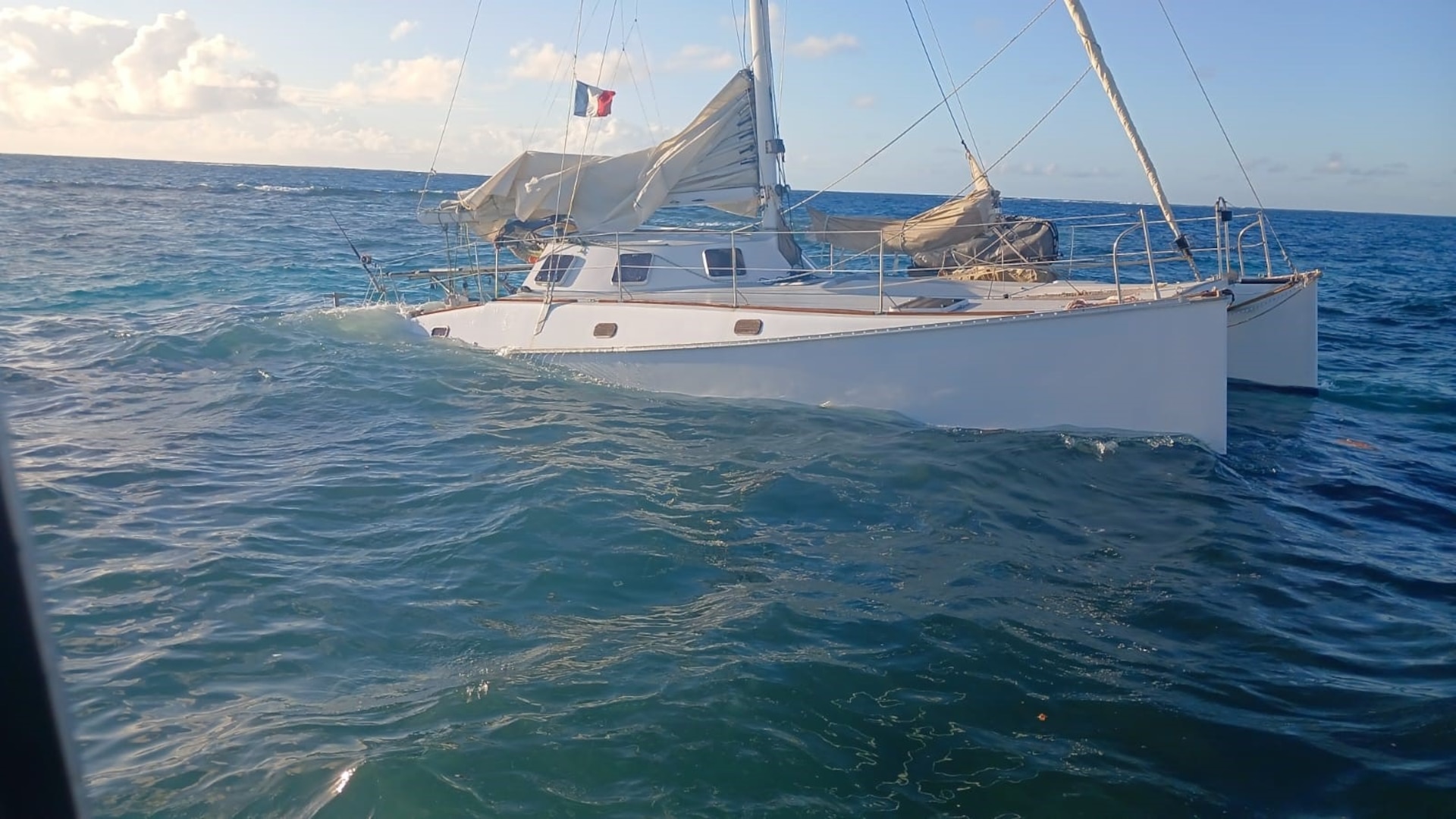 The sailing vessel Quartz partially submerged in waters southeast of Anegada, British Virgin Islands, after Coast Guard and Virgin Islands Search and Rescue (VISAR) units responded to a Mayday call in which a VISAR marine unit rescued three adult boaters during the early morning hours of March 7, 2024.  The boaters were forced to abandon the sailing vessel onto a dinghy, after the catamaran hit the rocks and started taking on water. (Photo courtesy of Virgin Islands Search and Rescue)