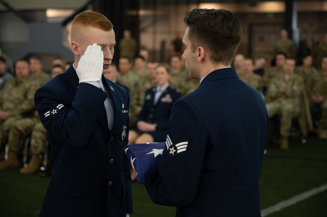 U.S. Air Force Airman 1st Class Ian Parker renders a salute to the American flag during a full honors funeral demonstration.