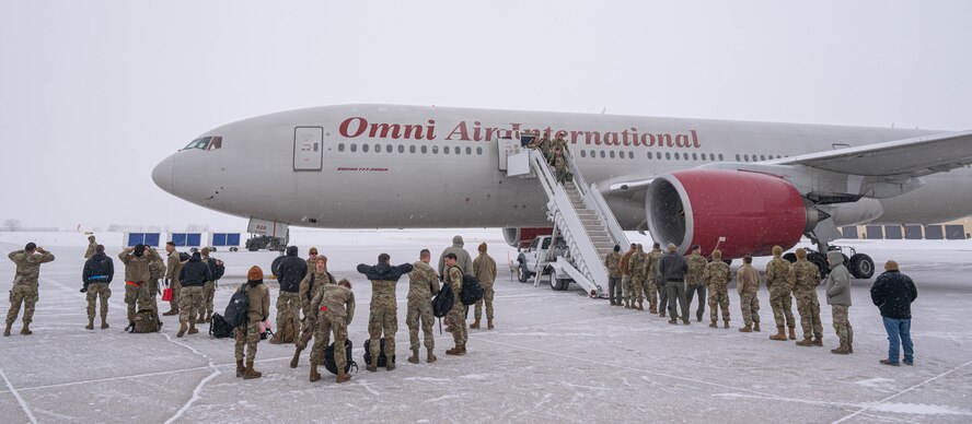 Airmen assigned to the 23rd Expeditionary Bomb Squadron return from a Bomber Task Force (BTF) mission at Minot Air Force Base, North Dakota, March 6, 2024. Airmen returned from a deployment to Anderson AFB, Guam, as part of a BTF mission which enhanced joint security strategies with allies and partners, demonstrating the U.S. capability to command, control and conduct bomber missions across the globe. (U.S. Air Force photo by Airman 1st Class Kyle Wilson)