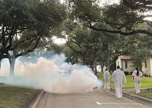 Members of the 12th Flying Training Wing create a methyl anthranilate fog to disperse nesting birds.