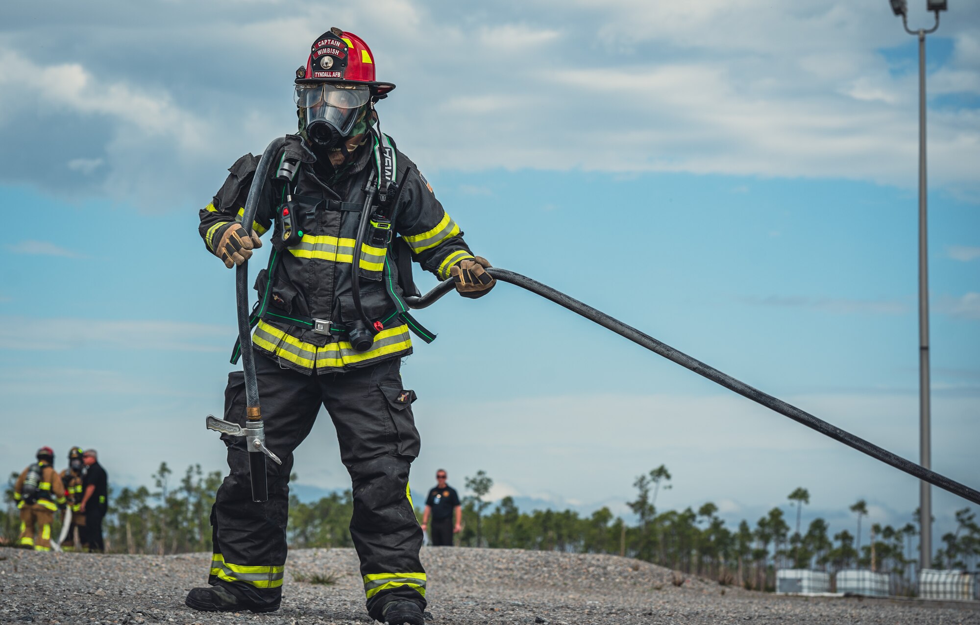 Airman pulls fire hose