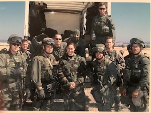 U.S. Air Force retired Tech. Sgt. Daylena Ricks, photojournalist, poses with special operations forces during a combat training exercise at Naval Air Station Fallon, Nevada, in 2000.