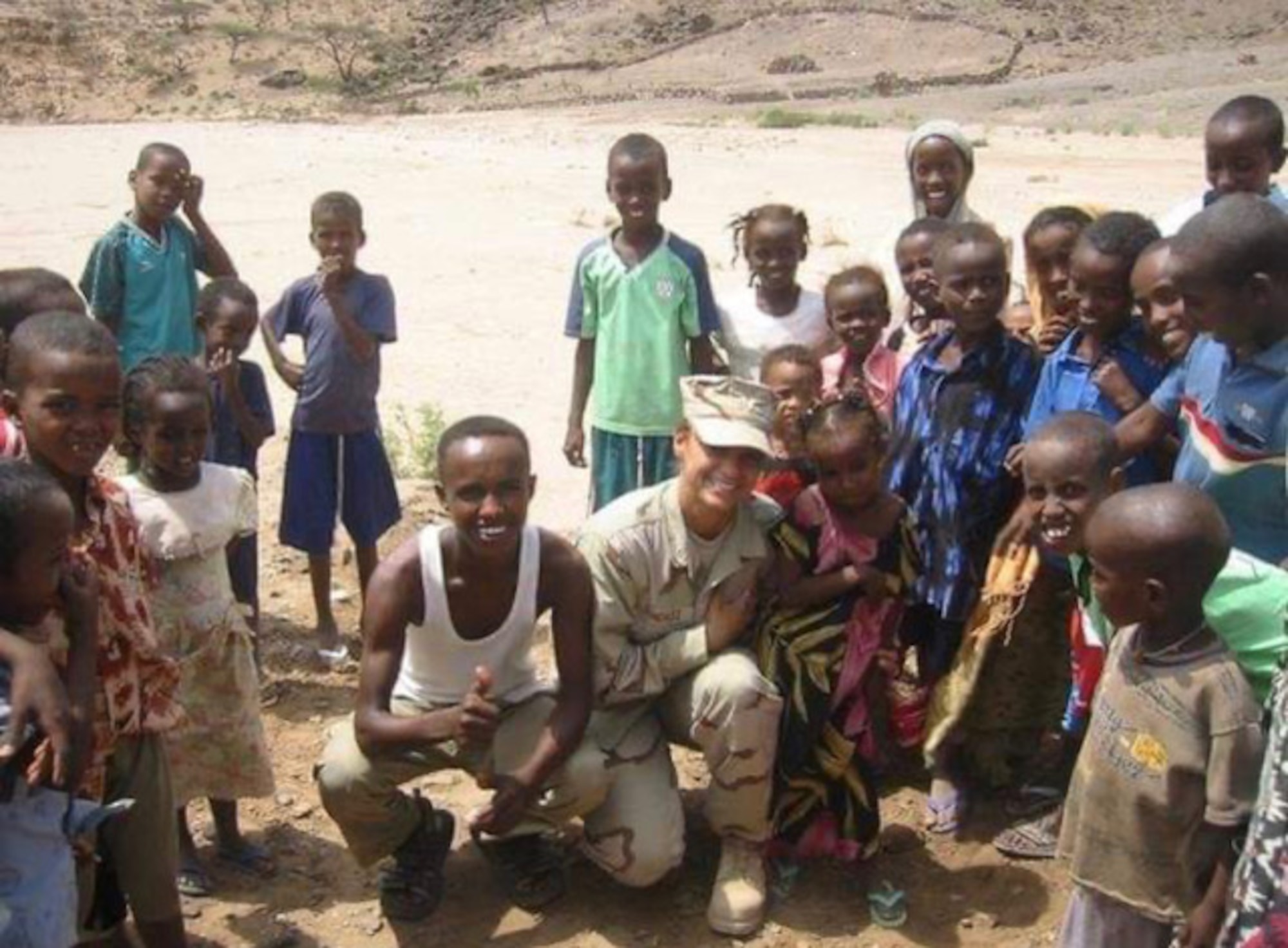 U.S. Air Force retired Tech. Sgt. Daylena Ricks, photojournalist, poses for a picture with local nationals while on a humanitarian mission in Addis, Ethiopia in 2007.