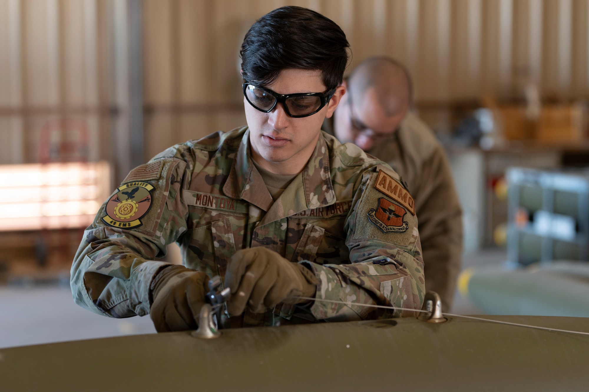 U.S. Air Force Senior Airman Samuel Montoya, 49th Equipment Maintenance Squadron crew chief, secures a wire on a Mark 82 live bomb at Holloman Air Force Base, New Mexico, Feb. 21, 2024. Assembling MK-82 bombs provides realistic training for Airmen in real-time war scenarios to test their readiness capabilities. (U.S. Air Force photo by Airman 1st Class Michelle Ferrari)