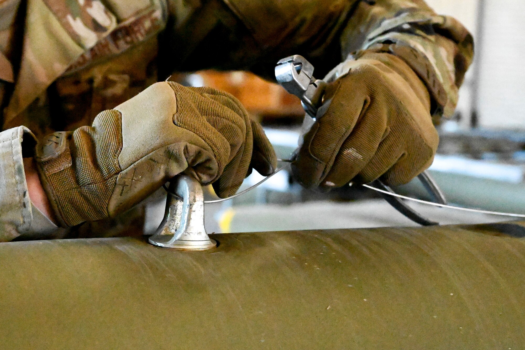An Airman from the 49th Equipment Maintenance Squadron puts together a Mark 82 bomb at Holloman Air Force Base, New Mexico, Feb. 21, 2024. The Mk-82 is a versatile bomb used for various operations that require meticulous assembly, enhancing the training environment to help develop Airmen. (U.S. Air Force photo by Airman 1st Class Michelle Ferrari)