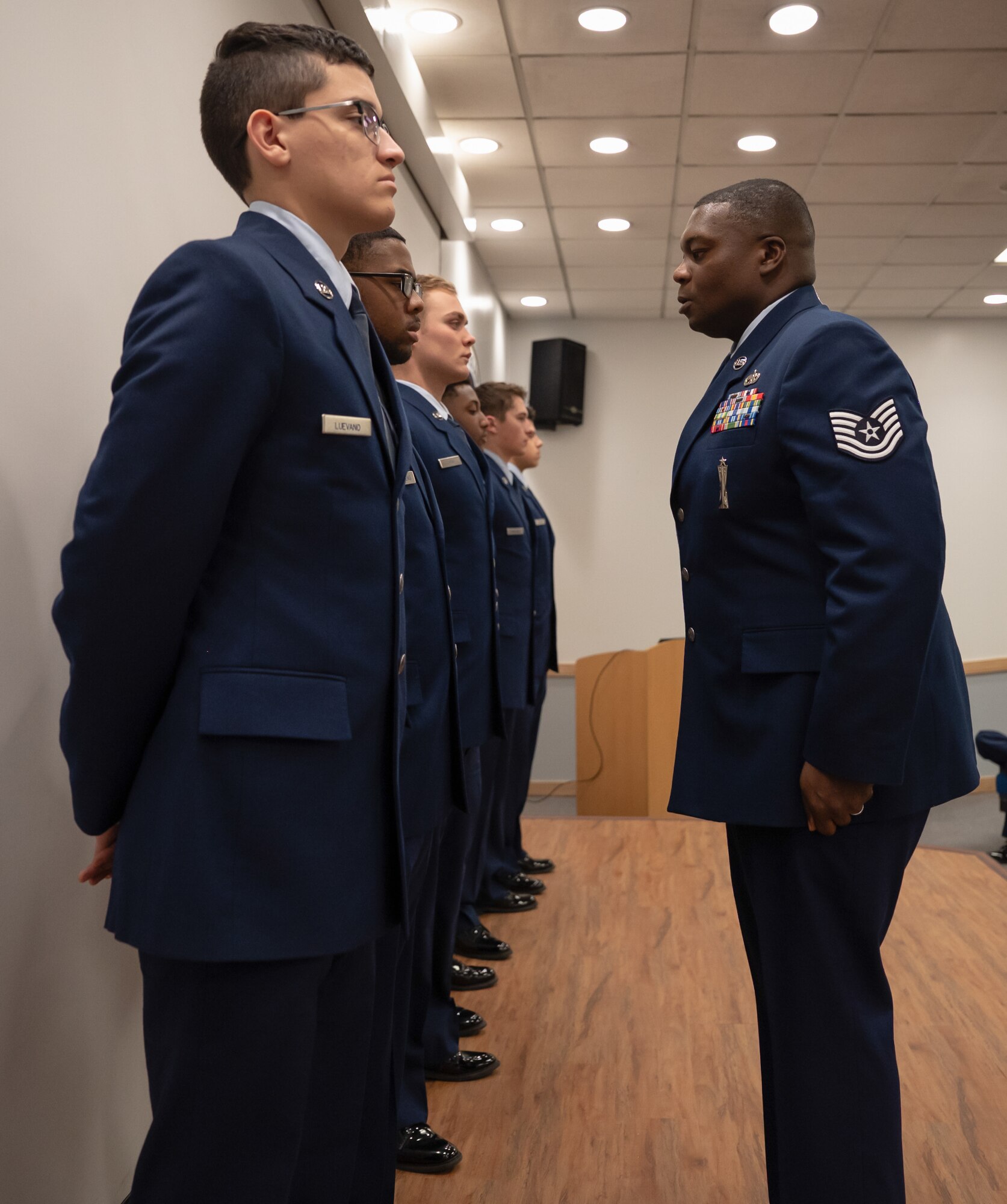 U.S. Air Force Tech. Sgt. Royce Sims, 51st Force Support Squadron noncommissioned officer in charge of FTEC, performs a dress uniform inspections at Osan Air Base, Republic of Korea, March 5, 2024. The inspection took place during a First Term Enlisted Course, a professional training course tailored to instill a mission-centric mindset in first-term Airmen following their technical training. Attention to detail when preparing uniforms reflects the discipline Airmen carry out when performing their daily duties in executing the 51st FW mission. (U.S. Air Force photo by Senior Airman Brittany Russell)