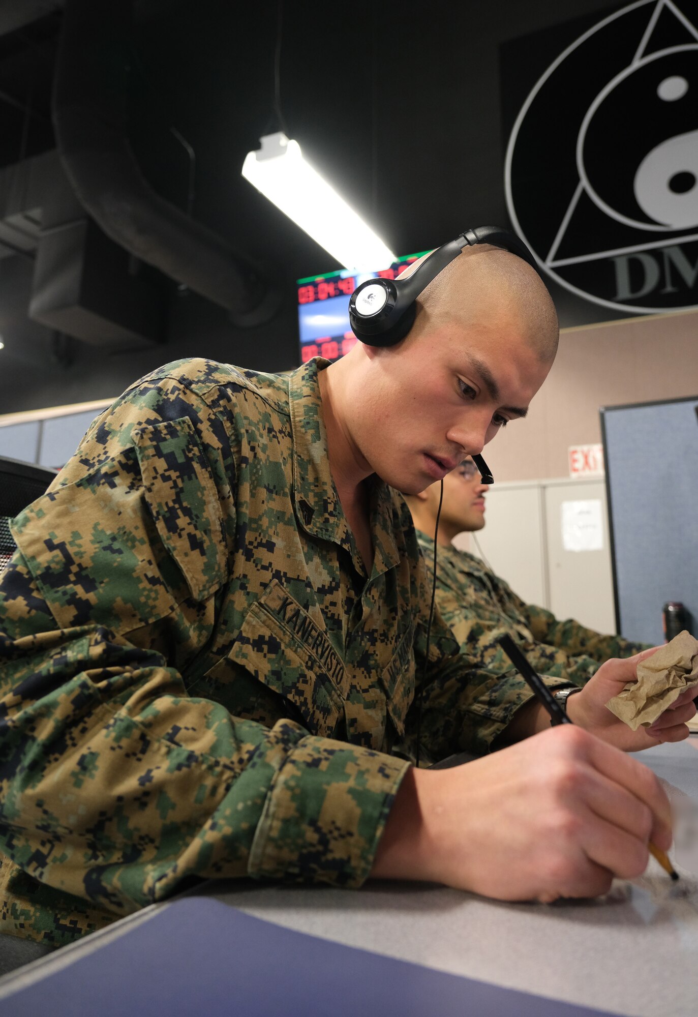uniformed U.S. Marine works at computer