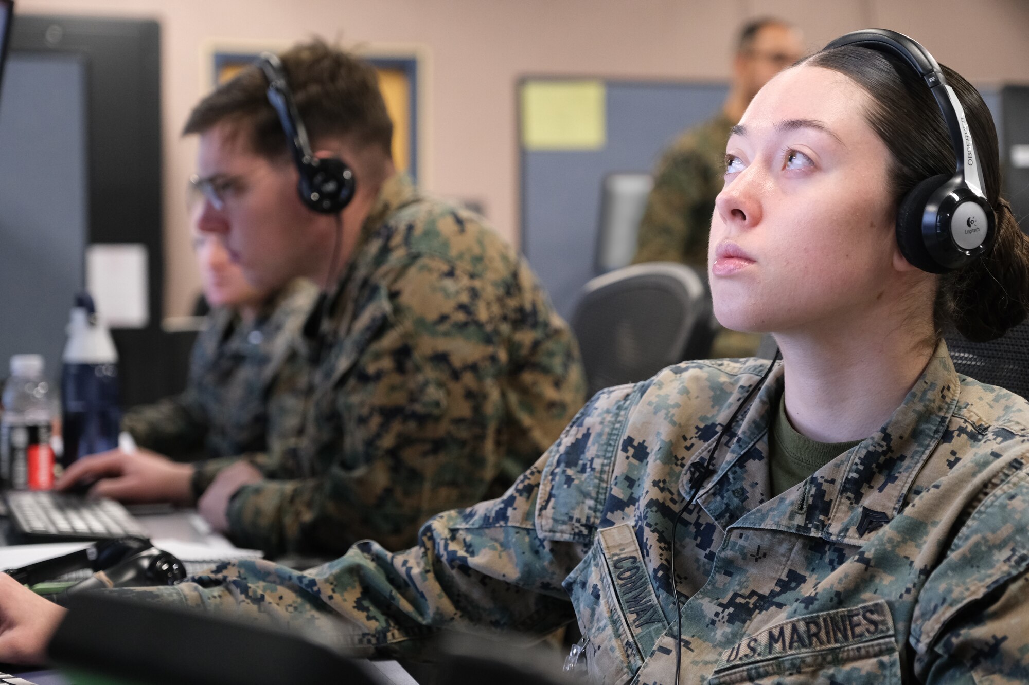 uniformed U.S. Marines work at computers