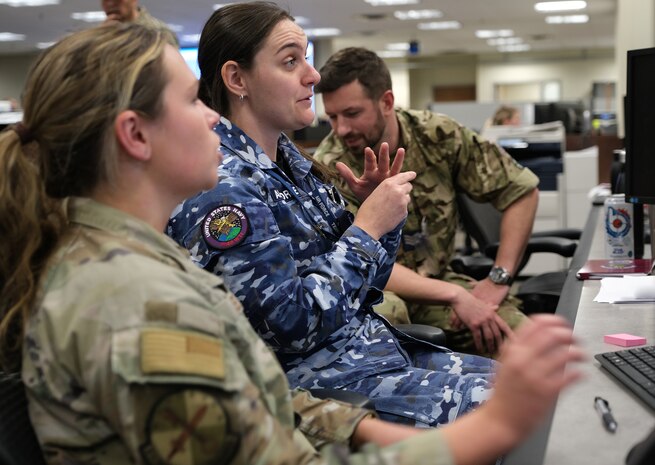 uniformed military members working at computers