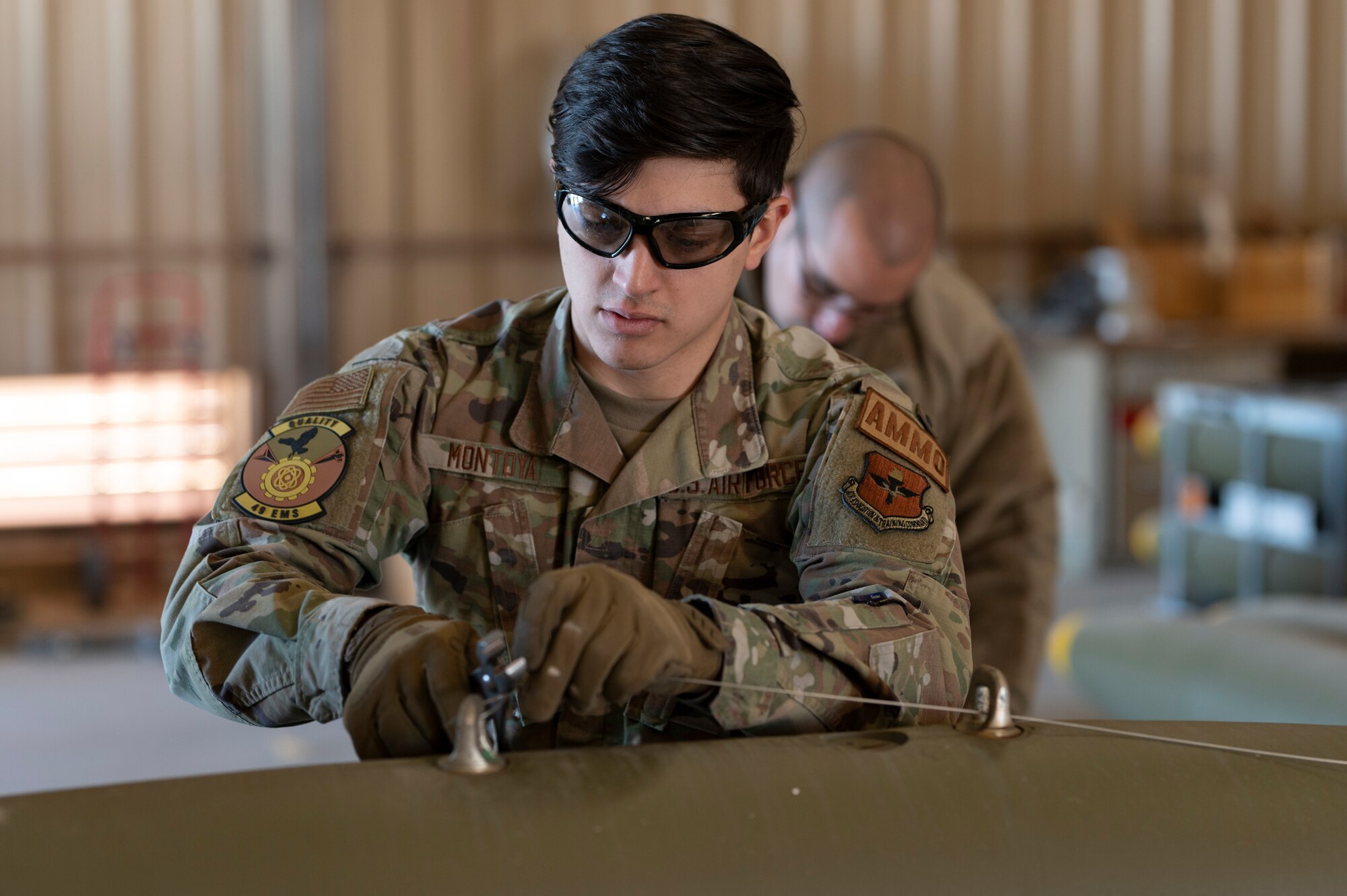 U.S. Air Force Senior Airman Samuel Montoya, 49th Equipment Maintenance Squadron crew chief, secures a wire on a Mark 82 live bomb at Holloman Air Force Base, New Mexico, Feb. 21, 2024. Assembling MK-82 bombs provides realistic training for Airmen in real-time war scenarios to test their readiness capabilities. (U.S. Air Force photo by Airman 1st Class Michelle Ferrari)