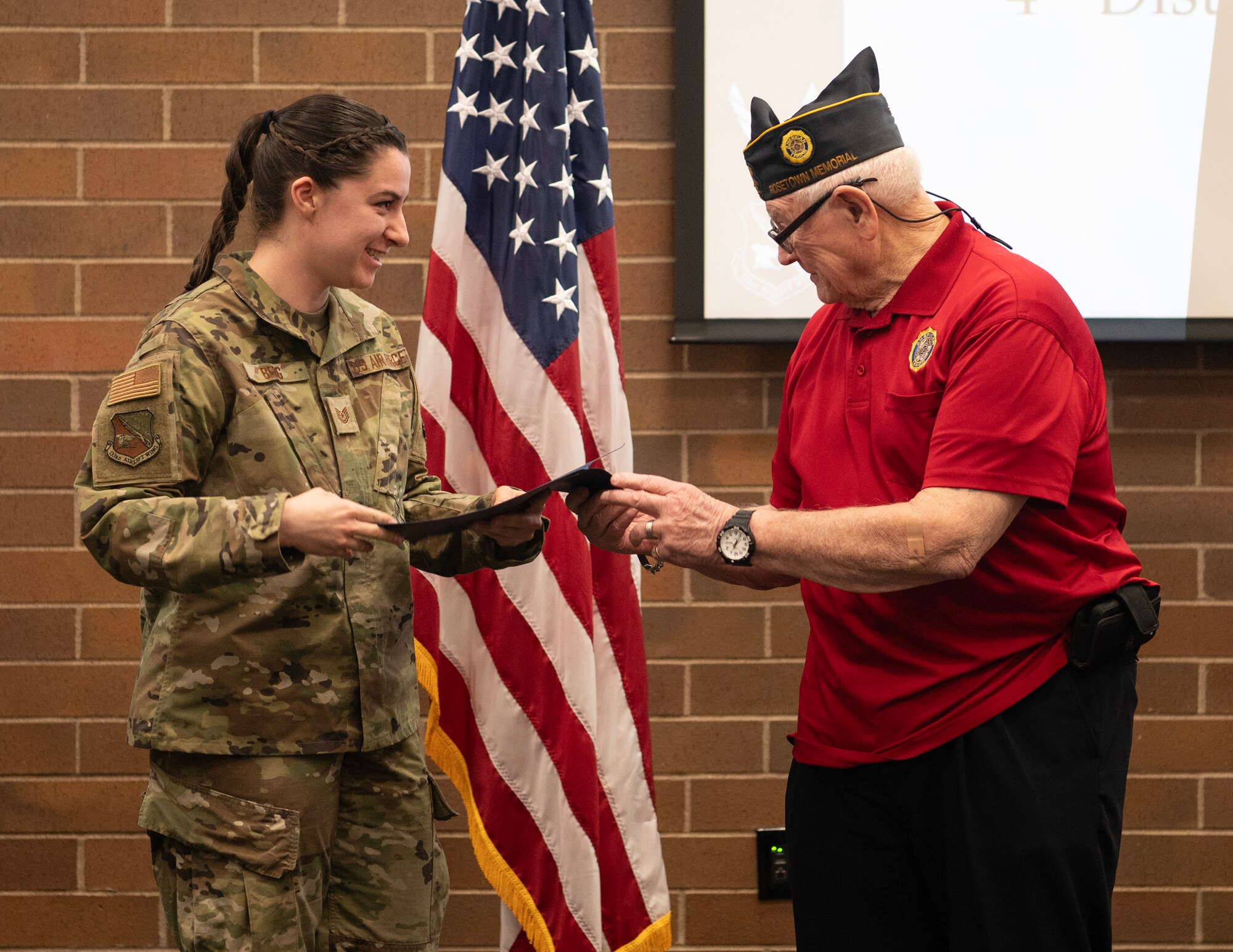 U.S. Air Force Tech. Sgt. Emily Berg, 133rd Maintenance Group, receives a certificate of appreciation from Veterans of Foreign Wars presented by Ken Gibson in St. Paul, Minn., March 2, 2024