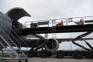 Crew members of the 18th Aeromedical Evacuation Squadron load equipment during a training event at Joint Base Pearl Harbor-Hickam, Hawaii, Feb. 26, 2024. The team worked with several organizations to coordinate and set up specialized medical equipment that will be used to execute the first AE mission carried out on a KC-46 Pegasus in the Pacific Air Forces area of responsibility. (U.S. Air Force photo by Technical Sgt. Tarelle Walker)