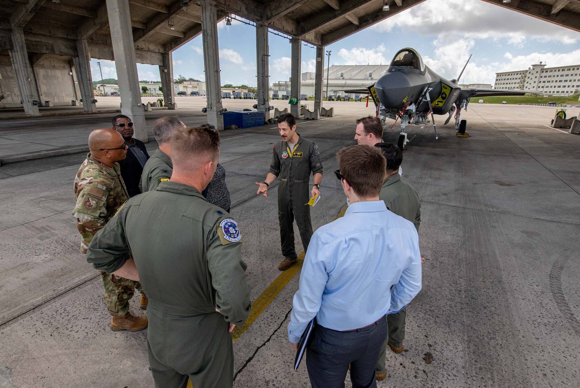 A group talks in front of an F-35A Lightning II.