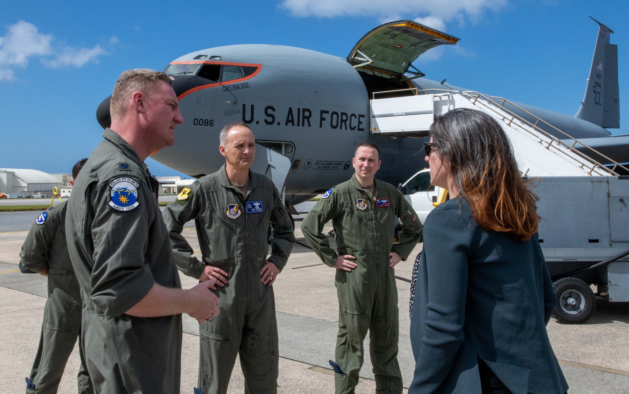 A group talk in front of a KC-135 Stratotanker.