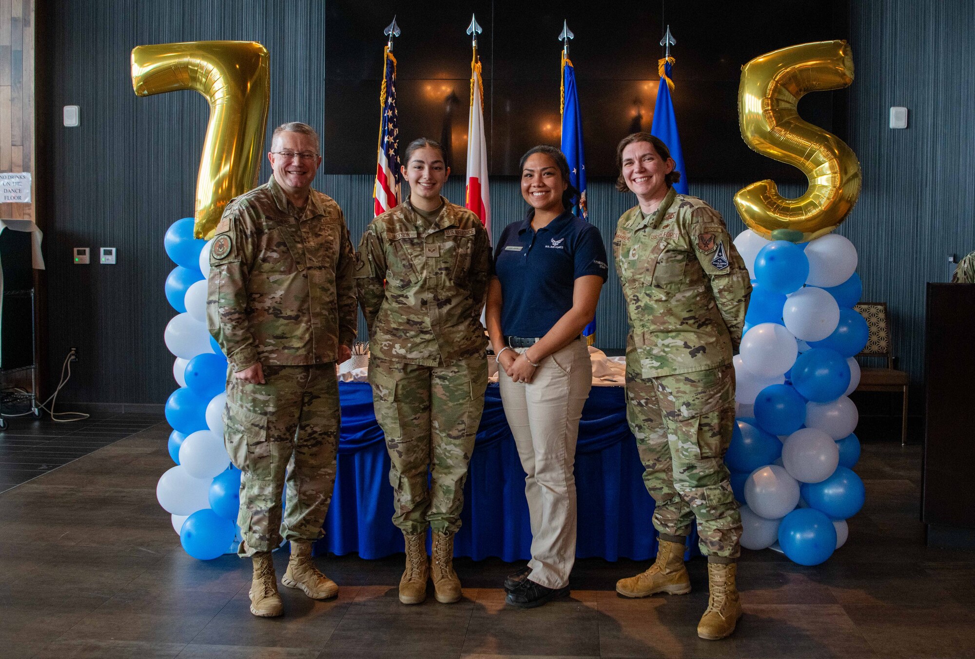 Four people pose for a photo.